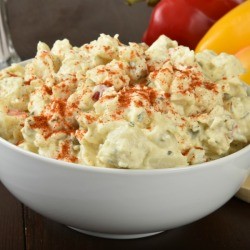 bowl of potato salad sprinkled with paprika