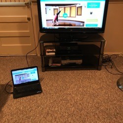 A computer being projected onto a TV screen.