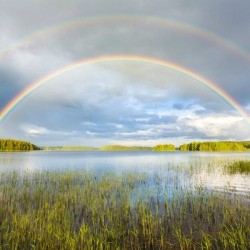 Double rainbow over a lake.