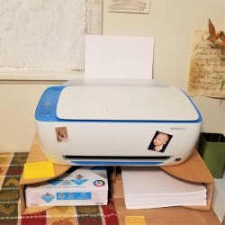 Two magazine holders attached together and used as a printer shelf.