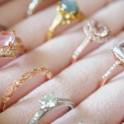 A collection of antique rings displayed on a pink display.