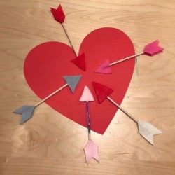 Arrow Toss Valentine's Day Toddler Game - heart with the arrows arrayed around it 
