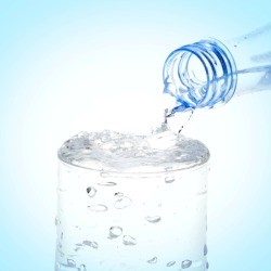 Pouring a glass of club soda.
