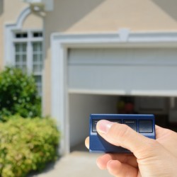 A garage door being opened by a remote.