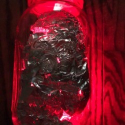 Foil Lined Mason Jar Light - glowing red light filled Mason jar