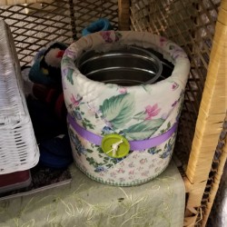 Camouflage Your Trashcan - small trash can on rattan shelf