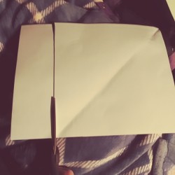Cutting the excess off to make a perfect square.