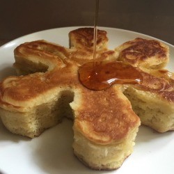 A fluffy Japanese style pancake in a snowflake shape with syrup.