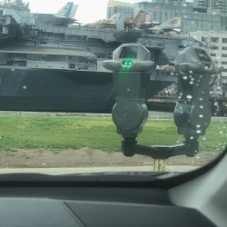 A parking meter that has a green light, denoting that there is time left.