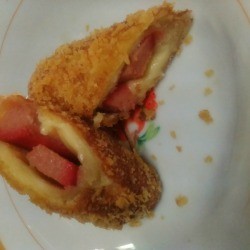 cut Cheesy Hotdog Bread Roll on plate