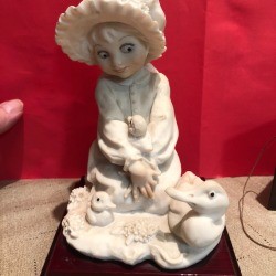 Value of a Guiseppe Armani Capodimonte Figurine - girl wearing a bonnet holding a baby duck 