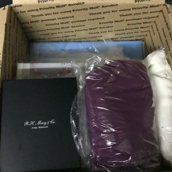 A moving box with clothing used as packing material.