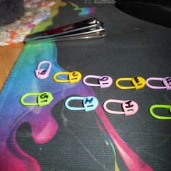 A collection of colored stitch markers with numbers denoted.