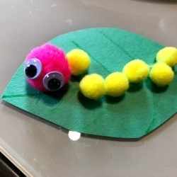Making a Pom Pom Caterpillar - closeup of finished caterpillar on a leaf