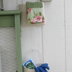 Bucket Garden Storage - 2 pails hanging on the side of a garden storage building