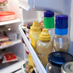 An open refrigerator with some disarray.