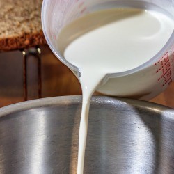 Pouring cream into a pan.