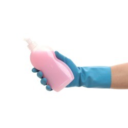 Hand in a rubber glove holding pink dish soap.