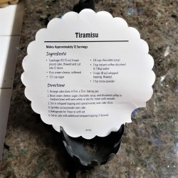 A recipe propped on the tines of a spaghetti spoon.