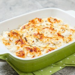 A casserole dish containing baked cod.