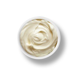 A bowl of mayonnaise on a white background.