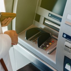 A person using an ATM at a bank.