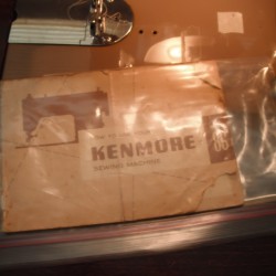 An old Kenmore sewing machine manual in a plastic bag.