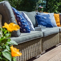 An outdoor couch with lots of cushions.